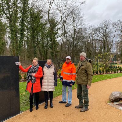 Bild vergrößern: Bürgermeisterin Steffi Syska zeigt exemplarisch eine Platte, wie  man sie an der neuen Stele befestigen kann. Neben ihr Kathleen  Deutschbein, Thomas Eisel und Thomas Tschitschmann.